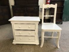 A contemporary white three drawer chest with chair