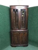 An inlaid mahogany double door corner display cabinet
