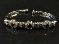 A sapphire and diamond bracelet set in white gold, diamond weight estimated at 1 carat, 23.