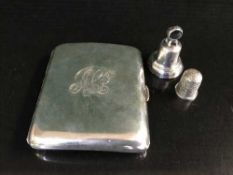 A silver cigarette case together with a silver thimble and bell