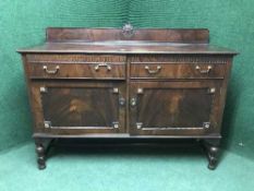 A late Victorian mahogany sideboard with brass drop handles