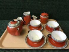 A fourteen piece Maling red Gosforth morning set together with a Maling rugby preserve pot