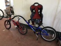 A boy's Huffy ignite mountain bike together with a Ali-cat bike attachment trailer and infant bike