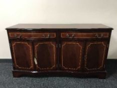 A serpentine fronted four door sideboard
