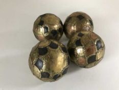 Four antique wooden balls mounted in brass and copper