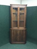 A Strongbow inlaid yewwod glazed door corner cabinet