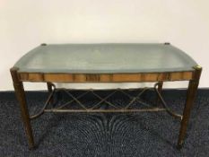 A continental walnut coffee table with etched glass top