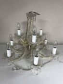 A decorative nine branch chandelier with glass drops