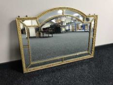 A shaped gilt framed over mantel mirror
