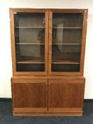 A mid 20th century teak glazed door bookcase