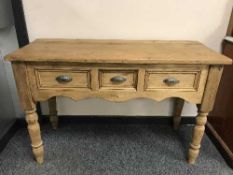 A Victorian style three drawer pine hall table