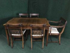 A shaped mahogany dining table and five chairs
