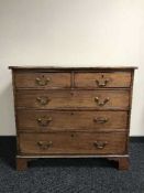 A Victorian inlaid mahogany five drawer chest on bracket feet