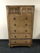 An early 20th century oak five drawer chest fitted a cupboard