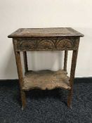 A heavily carved oak antique occasional table
