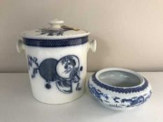 An oriental glazed pottery lidded jar and a shallow blue and white bowl depicting dragons