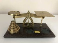 A set of brass postal scales with weights