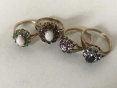 Four gold rings - Ruby and diamond, Sapphire and diamond, opal and emerald, opal and garnet.