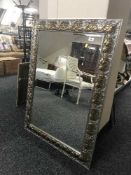 A decorative silver and gilt framed mirror