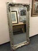 A tall bevelled silvered mirror