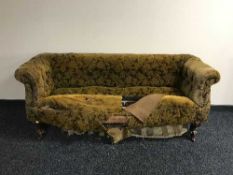 A Victorian upholstered club settee on carved mahogany legs