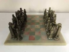 A marble chess board with metal pieces