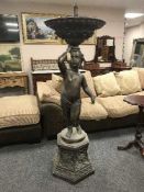 A bronze cherub fountain on hexagonal base