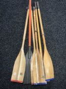 Five wooden oars and a paddle