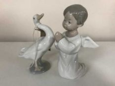 A Lladro figure - Cherub kneeling together Lladro swan