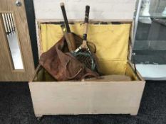 A painted pine blanket box containing two leather bags of vintage cricket equipment, tennis rackets,