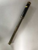 An early 20th century telescope with brass mounts