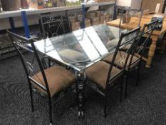 A metal based glass topped dining table and six chairs