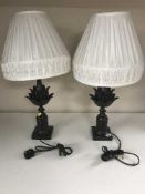 A pair of contemporary black table lamps with shades