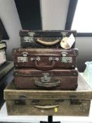 A mid 20th century pig skin luggage case and three others