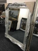 A bevelled silvered overmantel mirror