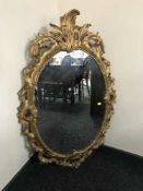 An un-framed continental oil on canvas - figures working in a field and a large decorative gilt