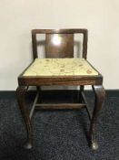 A walnut piano stool
