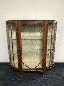 A walnut D-shaped display cabinet