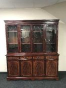 An inlaid mahogany four door glazed bookcase