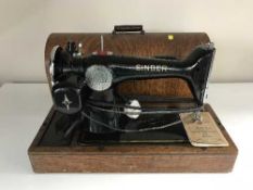 A mid 20th century oak cased Singer sewing machine