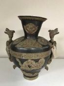 An Chinese bronze vase with gilt metal highlights depicting dragons
