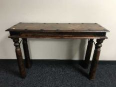 A hardwood hall table with metal mounts