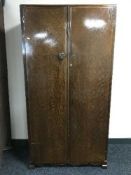 A fitted oak double door gentleman's wardrobe