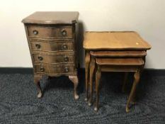 A mahogany serpentine fronted four drawer chest and nest of tables