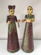 A pair of Indian hand painted wooden figures