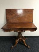 A Victorian mahogany tea table on pedestal support