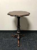 A mahogany pedestal occasional on carved support