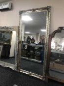 A large silvered bevelled overmantle mirror