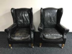 A pair of late 19th century leather wing back armchairs