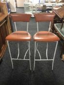 A pair of leather seated bar chairs